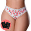 A curvy model wears a pair of crotchless peach print thongs with a satin bow next to 2 x sachets of peach flavoured lube.