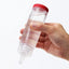 A hand model holds a clear squeeze bottle of water based lubricant in Tenga. 