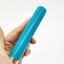 A hand model holds a blue rounded tip glassy vibrator for scale.