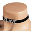 A mannequin wears a black velvet choker with movable letters on it spelling SLAVE.