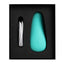 An aqua coloured clitoral vibrator sits in its package with its charging cable. 