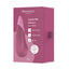 A dusty pink box by Womanizer stands on a white backdrop and has a noiseless dusty pink clitoral lay-on vibrator on it.