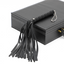 A faux leather flogger with a chain finger loops sits on a black briefcase.