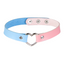 A two tone blue and pink faux leather leather choker with a metal heart connector. 