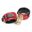 A pair of red wide faux leather wrist cuffs with an adjustable push-stud closure lays against a white backdrop. 