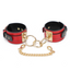 A pair of wide red faux leather ankle cuffs with non-swivelling gold o-rings.